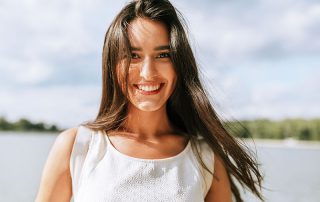 woman smiling outside during summer